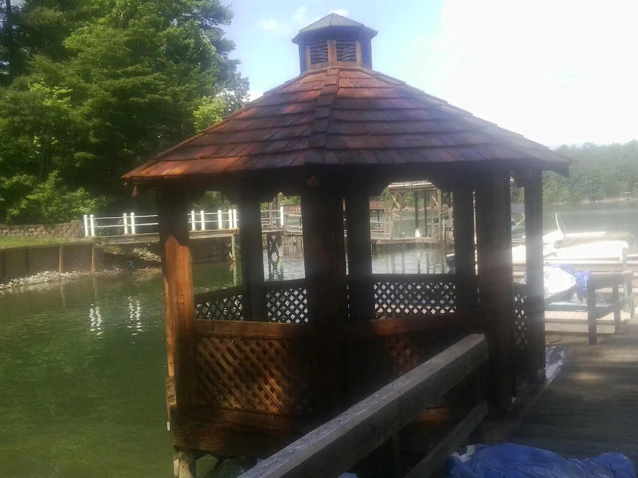 Cedar shake gazebo roof rebuilt on a lake dock in Seville